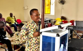 Sir Joe redaing Owusu Kwarteng Profile at Kumawu Presby Church